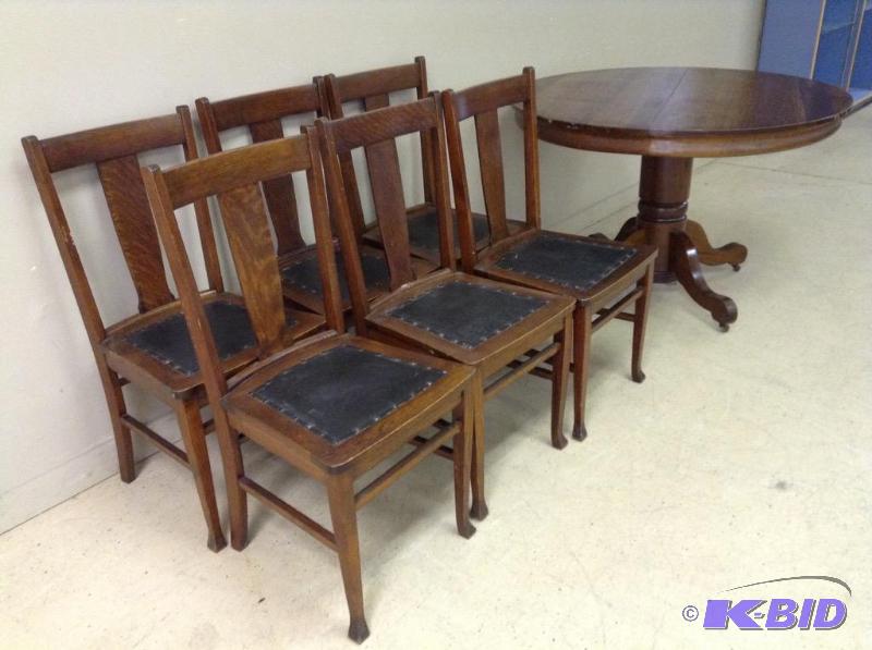 lot 3 image: Vintage tiger wood table with six wood and leather chairs.