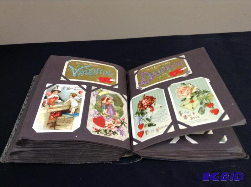 lot 52 image: Antique postcard album with postcards