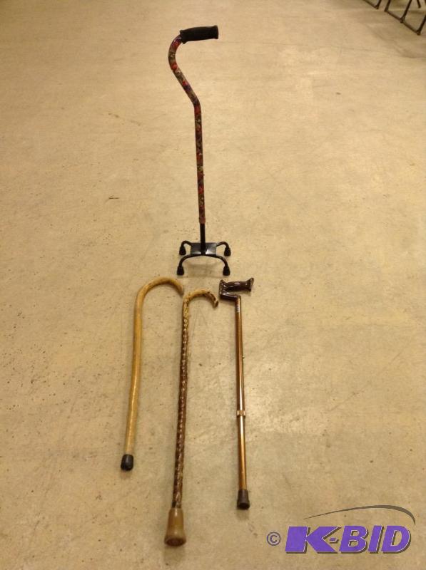 lot 87 image: Lot of wood and aluminum canes. One is a quad cane