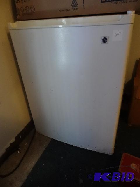 lot 26 image: Mini GE Refrigerator. Works. Needs cleaning....
