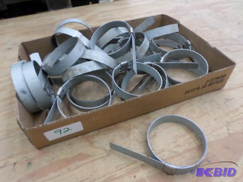 lot 92 image: Box Of Numerous 4" Hose Clamps...