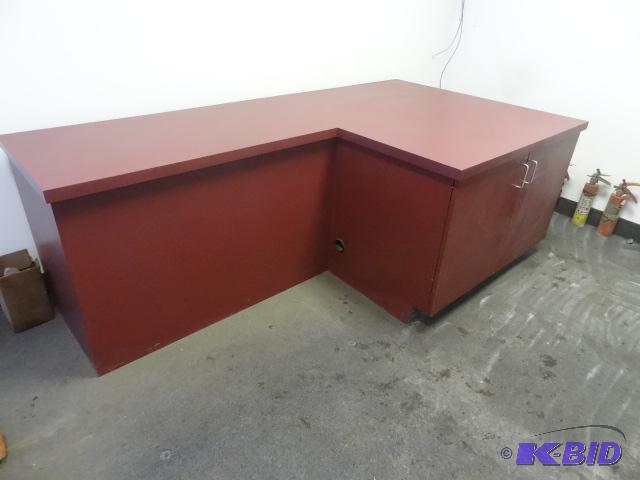 L Shaped laminate desk. 2 storage doors. Buye...