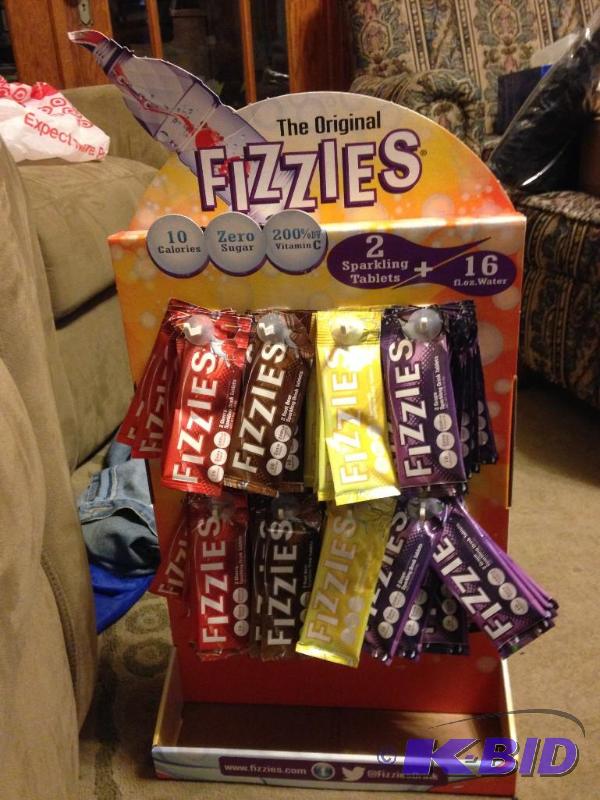 lot 103 image: Unopened Case of Fizzies.  Includes display board and 92 packages of Fizzies (2 per pack).  Just add these to water and you have a great beverage.  Grape, Cherry, Lemonade and Root Beer.