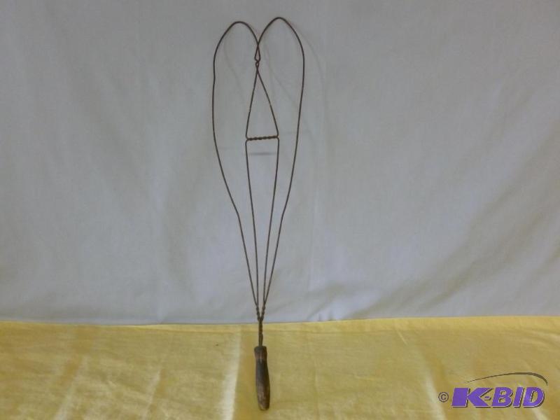 lot 28 image: Large antique wood handled rug beater that me...