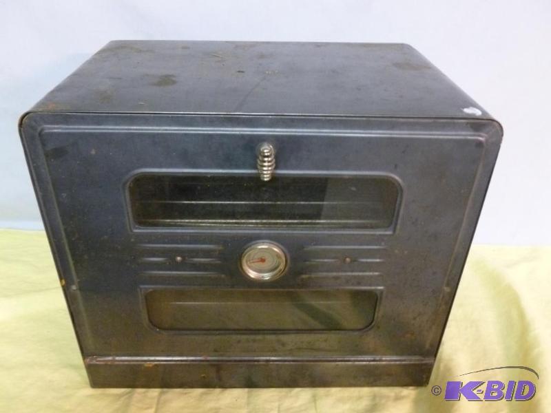 lot 6 image: Vintage double handled metal warming oven tha...