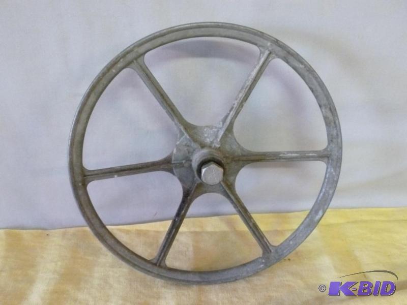 lot 78 image: Large metal pulley that measures 11" acr...