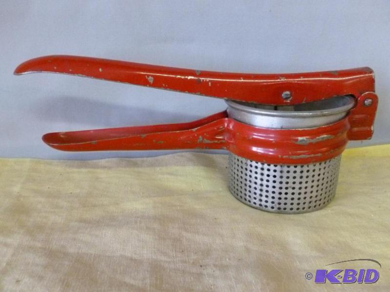 lot 94 image: Large vintage metal ricer that measures 10 3...