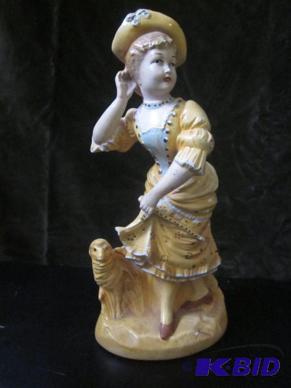 lot 36 image: 10 inch Antique chalk ware lady and dog. ...