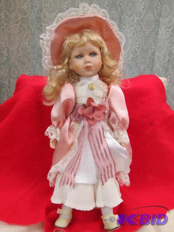 lot 40 image: A little girl in a dress and come with stand...