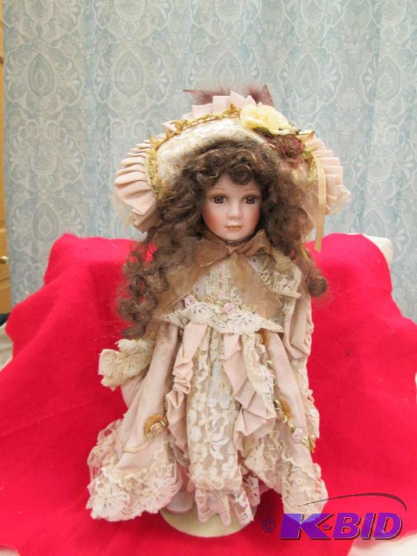 lot 42 image: A little girl in a dress and come with stand...