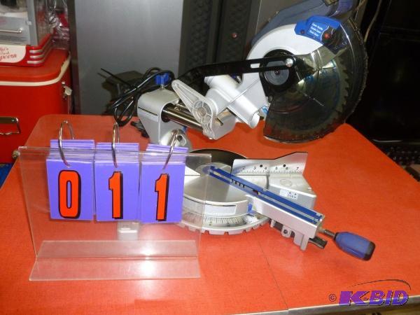 lot 11 image: Kobalt 7.25 compound slide miter saw. Appears...