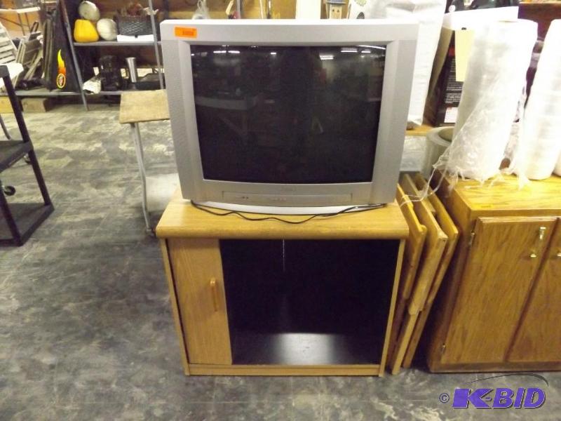 lot 242 image: Phillips TV with remote, light colored TV stand