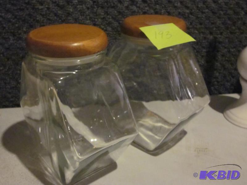 Pair of glass cannisters with wood tops.&nbsp...