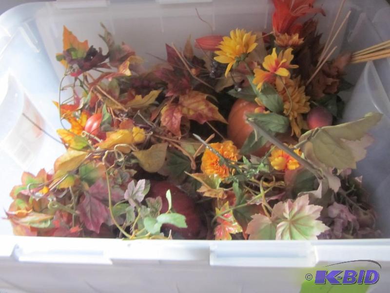 Bin full of autumn themed artificial flowers,...