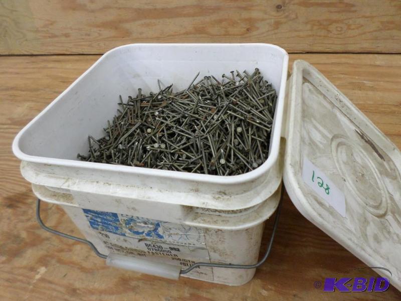 lot 128 image: Partial Bucket Of Blue Ox 4" Nails...