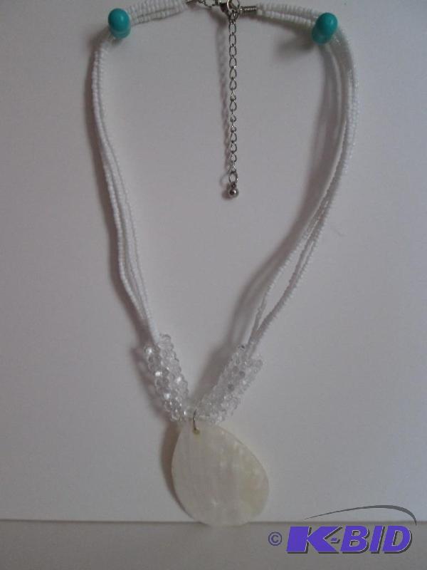 lot 26 image: White beaded necklace with shell center piece...