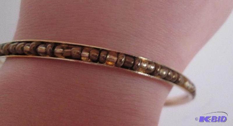 lot 32 image: metal framed braclet with beads brown beads...
