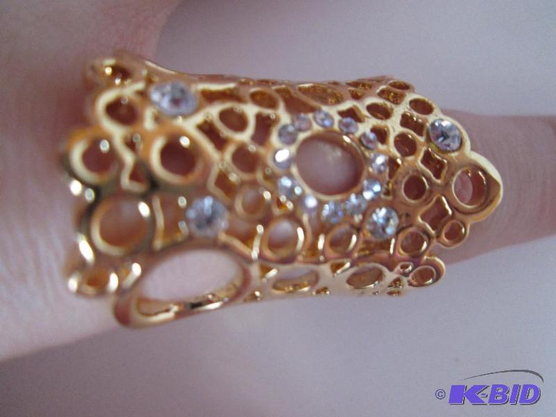 lot 64 image: Gold colored ring with rinestones...