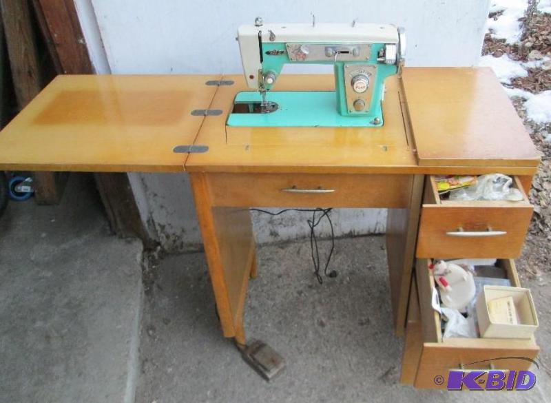 lot 157 image: Vintage sewing machine on wood table stand, d...