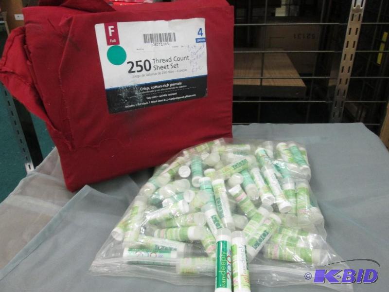 lot 297 image: full size bed sheet, bag of lip care balm...