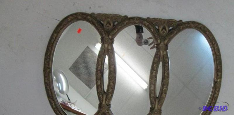lot 48 image: Mirror that has 3 different sections with a d...