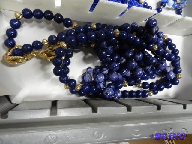 lot 130 image: Lot of 2 blue and gold womens necklaces...