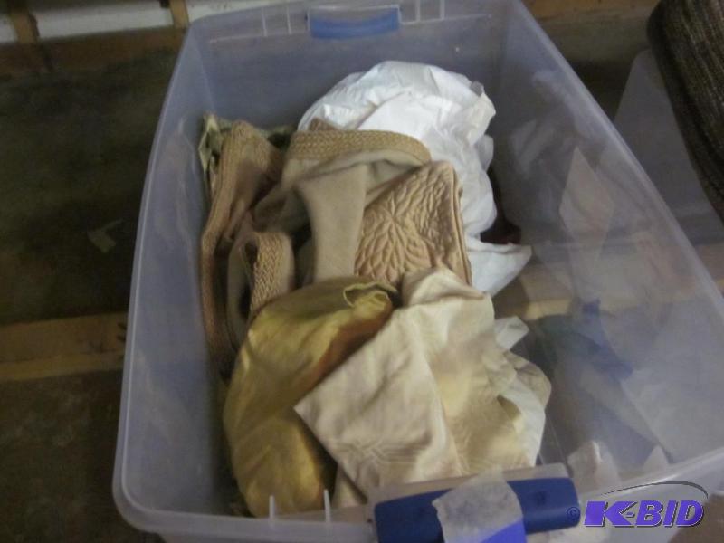 Bin with miscellaneous linens and pillow sham...
