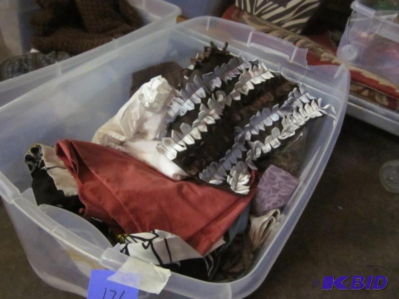 Bin with miscellaneous linens, pillow shams, ...