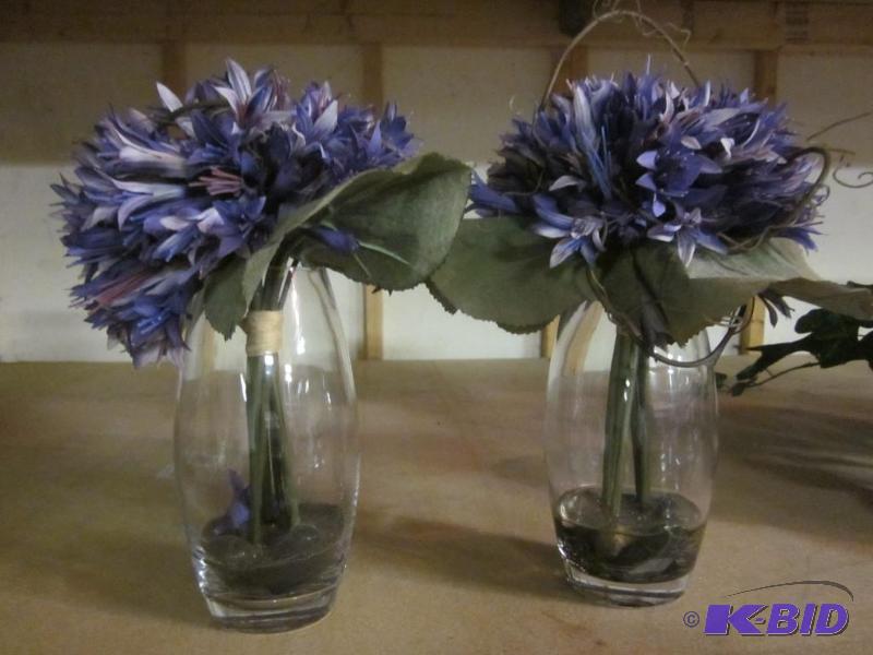 Pair of glass vases with artificial flowers. ...