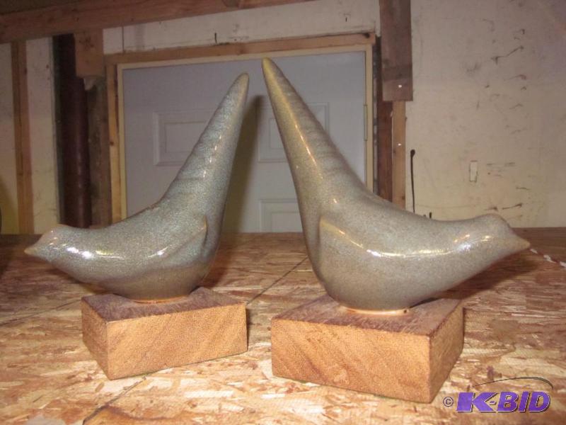 Pair of decorative ceramic birds on wood base...