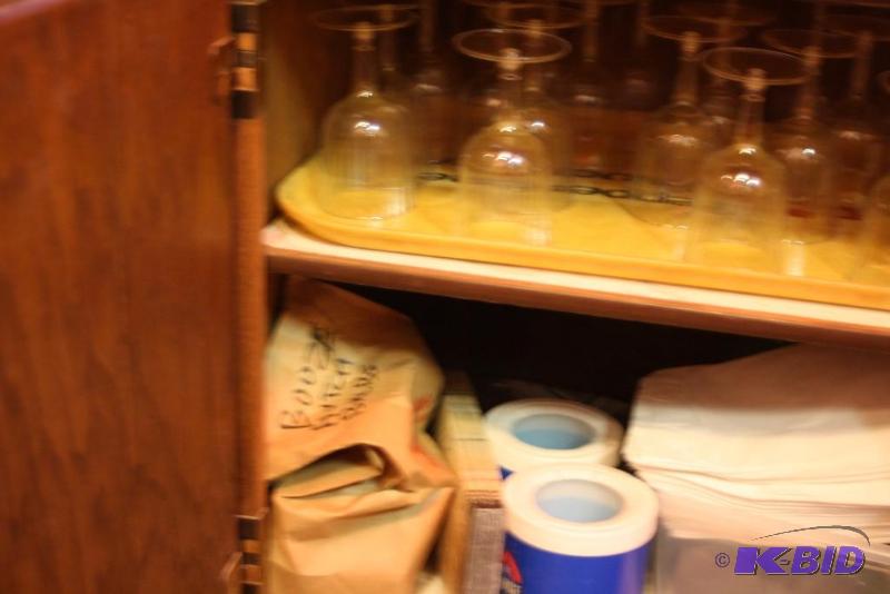 lot 129 image: Contents of Kitchen Including Glassware Cleaning Supplies Bottel Openers And More.