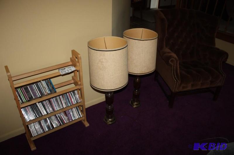 lot 237 image: (4) Including Wooden Lamps wBeige Shades, app. 2 ct Button-Back Chair wArm Rests CD Rack wCDs.