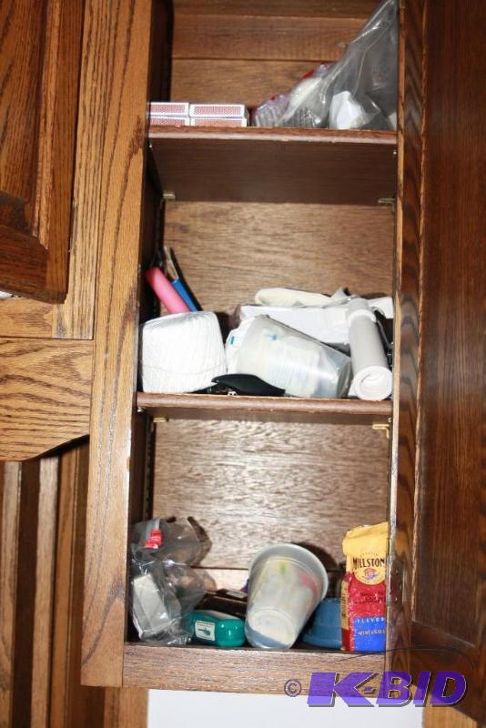 lot 239 image: Contents of Kitchen Cabinets Including Dishes, Seasonings, Kitchen Utensils, And More.