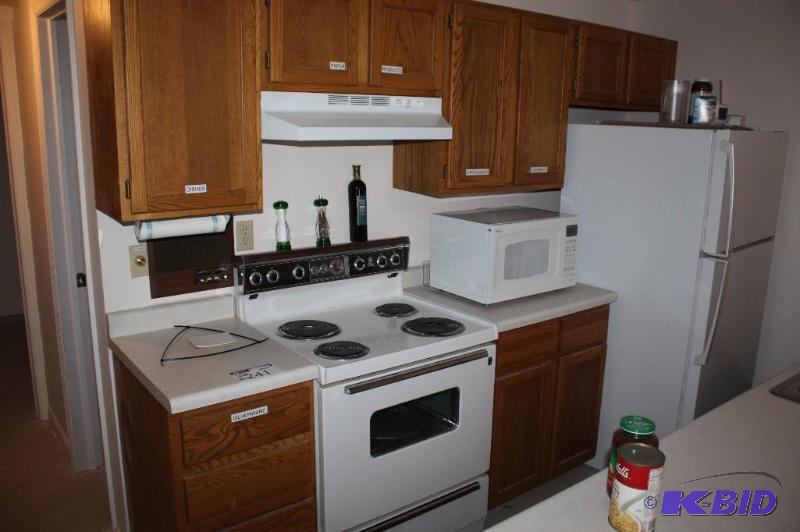lot 241 image: Contents of Kitchen Cabinets Including Dishes, Seasonings, Kitchen Utensils, And More.