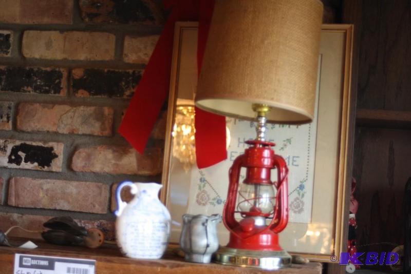 lot 59 image: Shelf Lot Includes Kerosene Lamp Style Lamp Wooden Barrel, Canvas Bag And More.