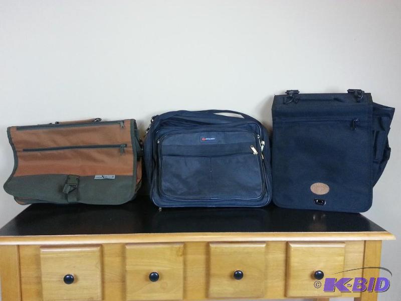 lot 57 image: Lot of (3) Portfolios Attaches Duluth Trading Company, Delsey, and Duck Wear