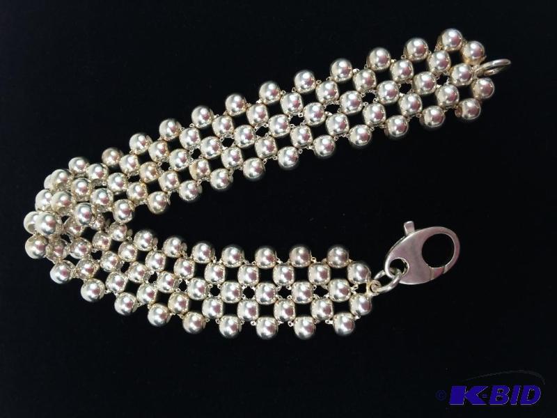 lot 1 image: Sterling Silver Bracelet  8L  5mm beads on woven box chain.  Total Wt. 30.0g.