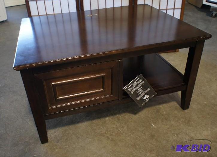 lot 28 image: New Ashley Signature coffee table - MSRP...