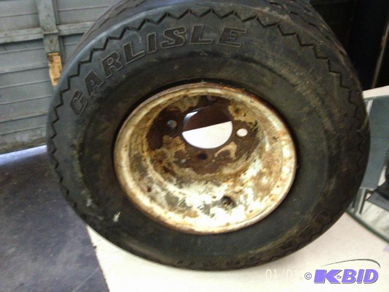 lot 32 image: Carlisle 15.5 x 8.5-8 trailer tire with rim. ...
