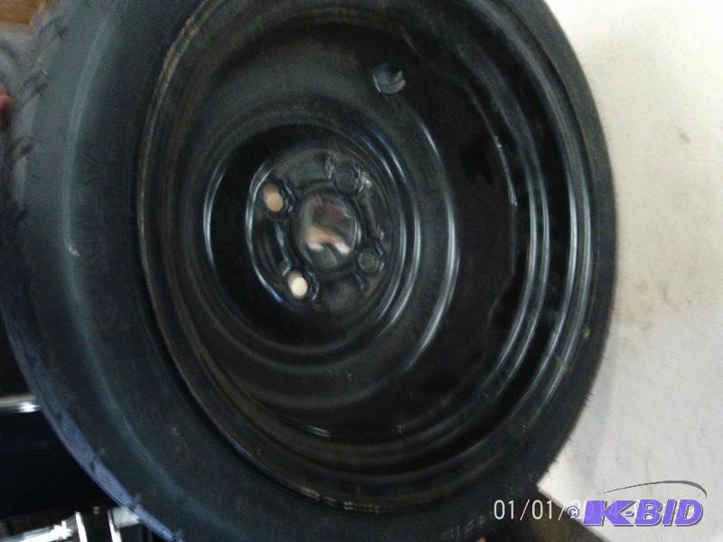 lot 33 image: 4 bolt spare tire with rin in good condition....