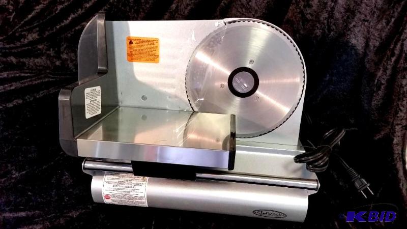 lot 32 image: Chefs Mark 200-Watt Meat Slicer.  New out of Box.  Tested Works Powers on.