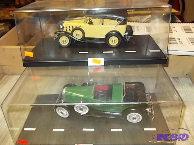2-Old Cars In Display Cases...