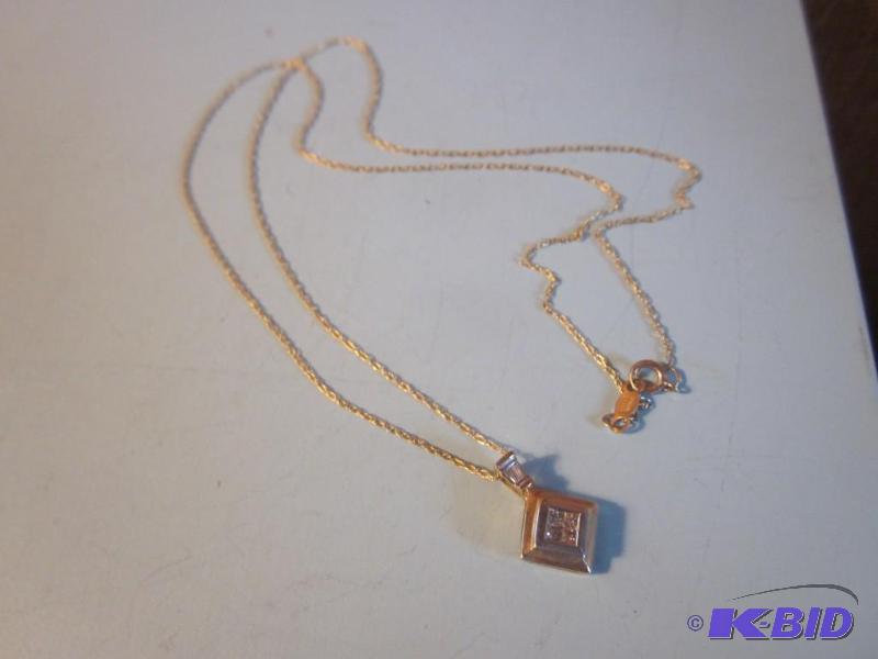 10 Karat yellow gold necklace with charm and ...