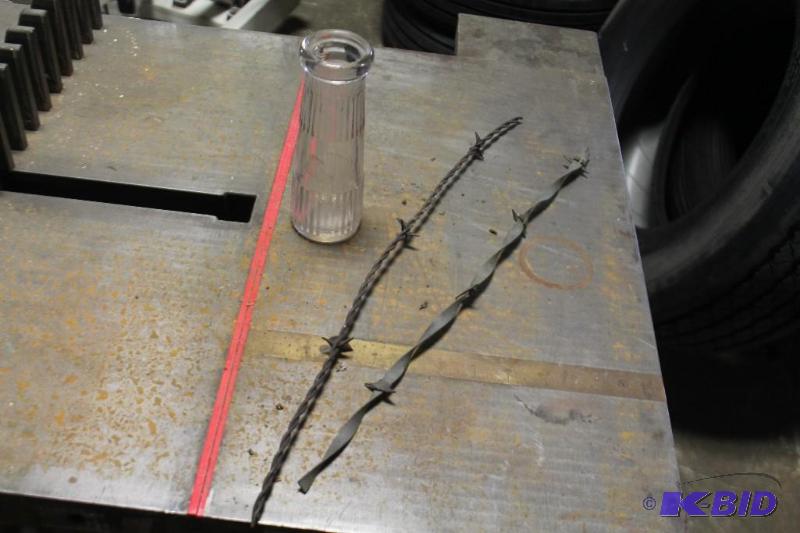 lot 14 image: Glass Vase and Strands of Barbed Wire