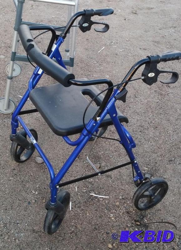 lot 34 image: Push walker with seat and brakes. Great condi...
