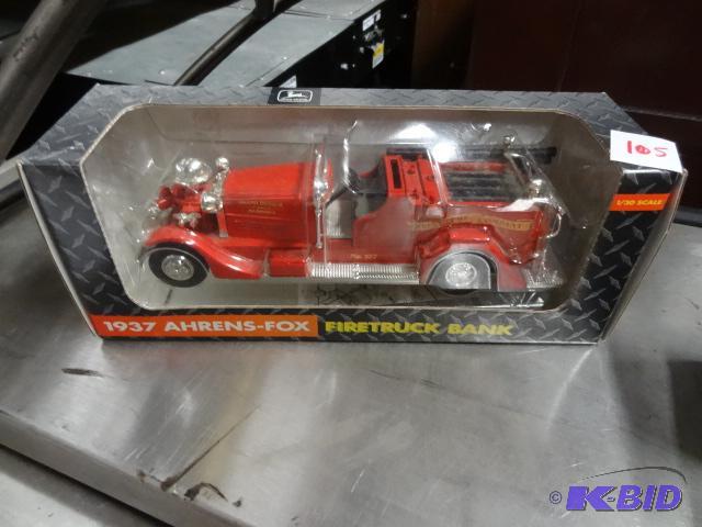 lot 105 image: 1937 Ahrens Fox fire truck bank. 130. John D...