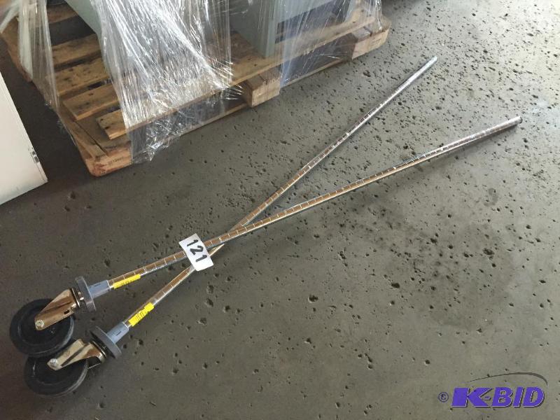 lot 121 image: 2 Metro style rack uprights with casters....