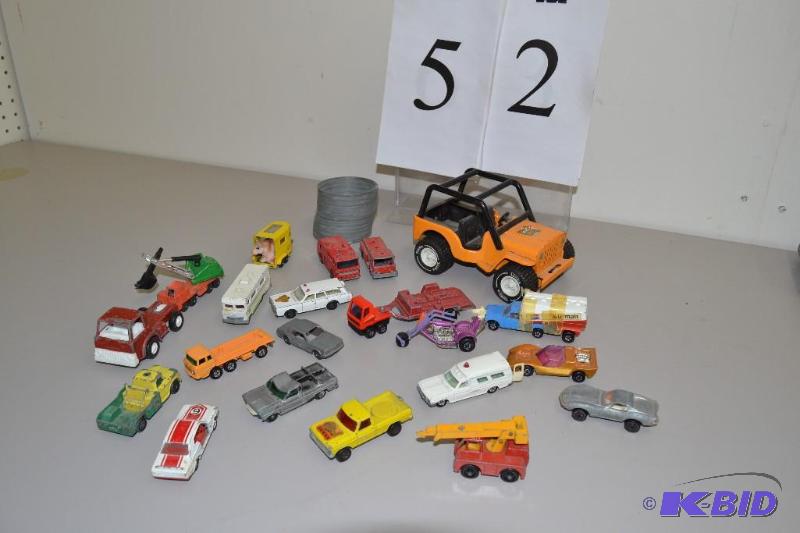 lot 52 image: Assortment of Vintage Matchbox, Tomica, and other toy cars and metal Slinky