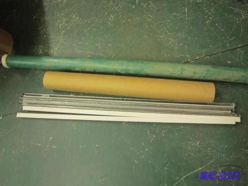 lot 517 image: Green Shipping Fishing Rod Tube, Metal Suspended Ceiling Brackets, and Brown Roll of Shipping Paper