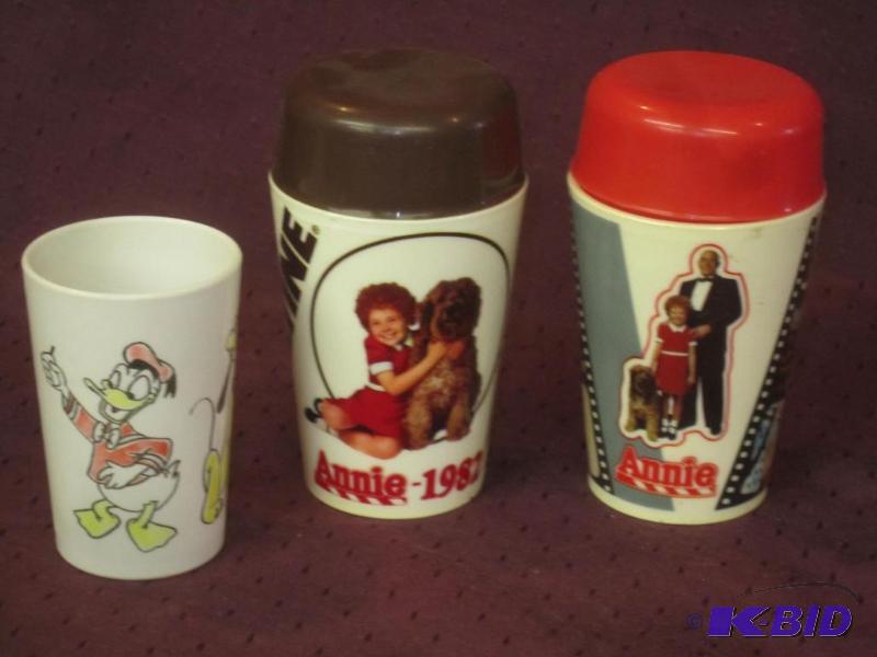 lot 544 image: 3 Cups  2 - 1982 Annie Cups with Lid, 1 - Walt Disney Cup